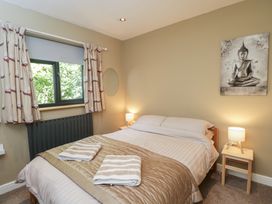 A bedroom with a bed and window at Willow Cottage in Whiteparish