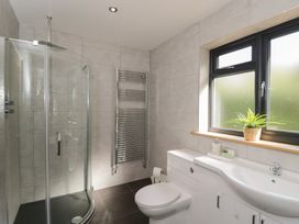 A bathroom with a shower, toilet and sink at Willow Cottage Whiteparish