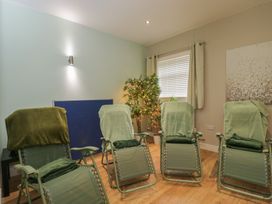 A relaxation room with reclining chairs and an indoor plant at Willow Cottage in Whiteparish