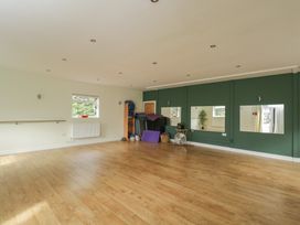 A studio with wooden floor and exercise equipment at Willow Cottage in Whiteparish
