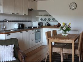 A kitchen with a dining table and chairs at Cottage 2