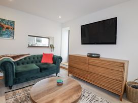 A living room with a sofa and television at Barn 2