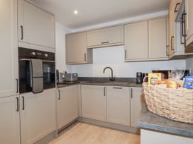A kitchen with kitchen cabinets and appliances at Barn 2