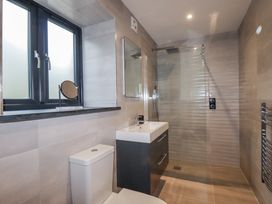 A bathroom with a shower, sink, and toilet at Barn 2