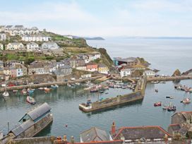 A coastal view of a harbor with boats and houses at Barn 2 in St. Ewe near Pentewan