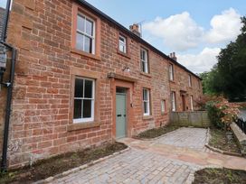 An exterior view of a stone house with a pathway at Milford in Wetheral