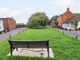 A park with a bench and a large tree at Milford in Wetheral