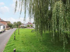 A park area with trees and benches at Milford in Wetheral