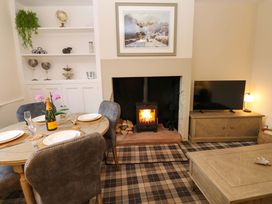 A dining room with a table and fireplace at Milford in Great Corby, Wetheral