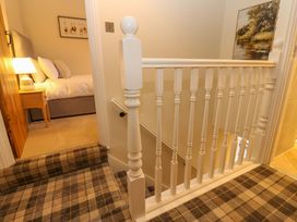 A hallway with a staircase and bedroom entrance at Milford, Great Corby, Wetheral