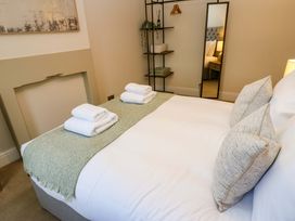 A bedroom with a bed and shelves at Milford in Great Corby, Wetheral