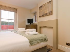 A bedroom with bed and television at Milford in Great Corby, Wetheral