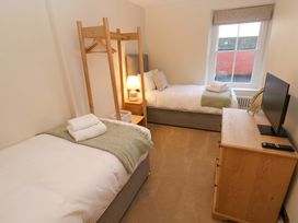A bedroom with two beds and a television at Milford in Great Corby, Wetheral
