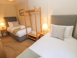 A bedroom with two beds and a lamp at Milford in Great Corby, Wetheral