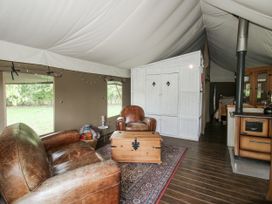 A living room with an armchair and coffee table at Hedgerow in Bewdley