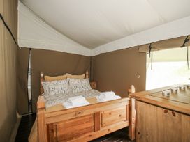 A bedroom with a bed and wooden furniture at Hedgerow in Bewdley