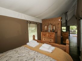 A bedroom with a bed and dresser at Hedgerow in Bewdley