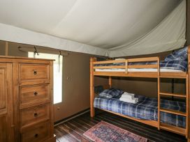 A bedroom with a bunk bed and a dresser at Hedgerow in Bewdley
