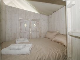 A bedroom with a bed and towels at Hedgerow in Bewdley