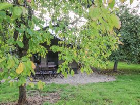 A table and chairs under a tree at Hedgerow in Bewdley