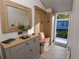 A entrance hall with a mirror and cabinets at Lakewood Retreat in Woodhall Spa