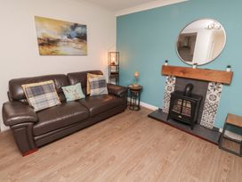 A living room with a sofa and fireplace at Nobles Nook in Seahouses