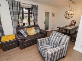 A living room with a sofa and dining table at Nobles Nook in Seahouses