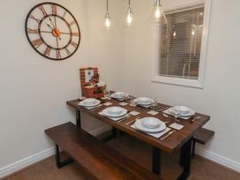 A dining room with a table set for dinner at Nobles Nook in Seahouses