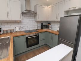 A kitchen with appliances and cabinets at Nobles Nook in Seahouses