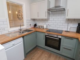 A kitchen with sink, oven, and countertop at Nobles Nook in Seahouses