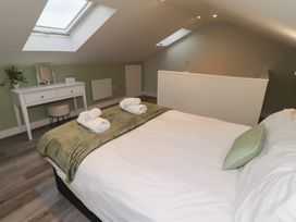 A bedroom with a bed and desk at Nobles Nook in Seahouses