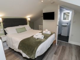 A bedroom with a bed and television at Nobles Nook in Seahouses