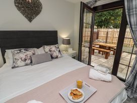 A bedroom with a bed and garden view at Nobles Nook in Seahouses