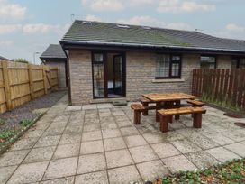 An outdoor area with a table and benches at Nobles Nook in Seahouses