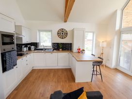 A kitchen with modern appliances and a dining area at Lodge 12 South Hykeham