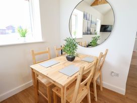 A dining room with a table and chairs at Lodge 12 South Hykeham