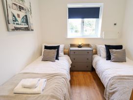 A bedroom with two beds and a nightstand at Lodge 12 in South Hykeham