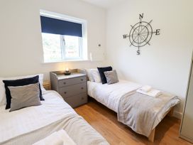 A bedroom with two beds and a nightstand at Lodge 12 South Hykeham