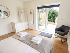 A bedroom with a bed and wardrobe at Lodge 12 South Hykeham
