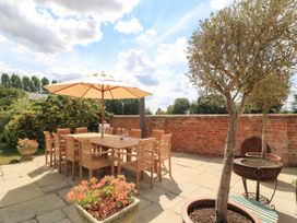 An outdoor dining area with a table and chairs at The Mount in Chippenham