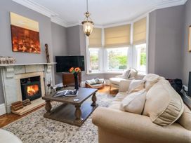 A living room with a television and fireplace at The Mount in Chippenham