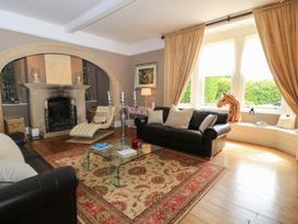 A living room with a fireplace and a coffee table at The Mount in Chippenham