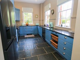 A kitchen with blue cabinets and a sink at The Mount in Chippenham