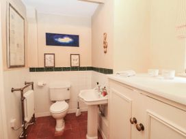 A bathroom with a toilet and sink at The Mount in Chippenham