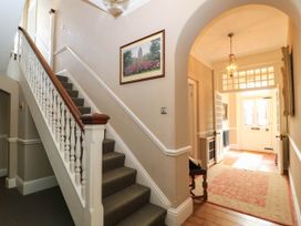 A hallway with a staircase and a door at The Mount in Chippenham