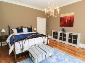 A bedroom with a bed and nightstand at The Mount in Chippenham