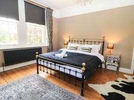 A bedroom with a bed and nightstands at The Mount in Chippenham