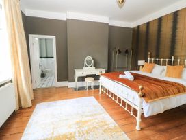 A bedroom with a bed and dressing table at The Mount in Chippenham