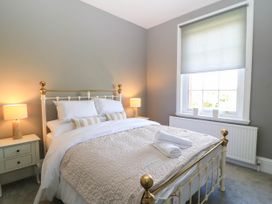 A bedroom with a bed and bedside table at The Mount in Chippenham