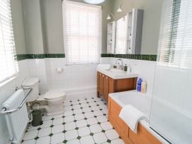 A bathroom with a toilet, sink, and bath at The Mount in Chippenham